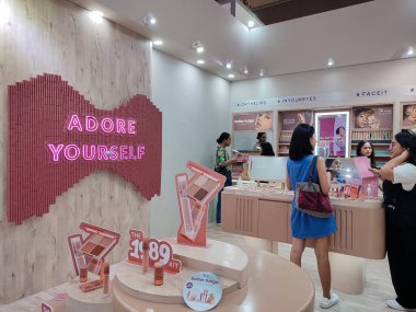 Jakarta, Indonesia - June 23, 2024: Jakarta Fair event held at Jakarta International Expo Kemayoran. Women browsing cosmetics on store booth. 