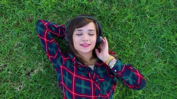 Top View Girl Lying Meadow Listening Music Her Headphones — Videoclip de stoc