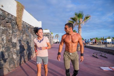 A couple trains together, boy and girl do a warm-up run before the workout