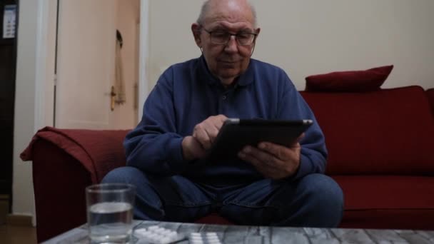 Elderly Man Takes Medicines Reads Medical Information His Tablet — Stock Video