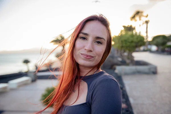 stock image Portrait of a smiling attractive girl on the seafront during sunset