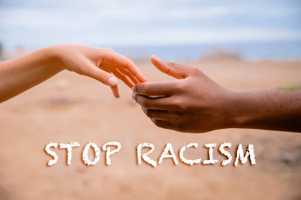 White hand of a woman and black of a man, concept of diversity and stop racism