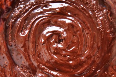 Çikolata kıvrımlı arka plan. Çikolatalı krema. Erimiş çikolata arkaplanı