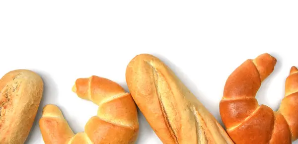 Fresh crispy baked bread banner panorama view. Crispy bread, French baguette and bagels with copy space.