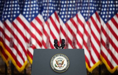 Empty Tribune for Speeches of American President With Microphones Against the American Flags Background. clipart