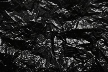 Plastik buruşmuş siyah polietilen çanta dokusu arka planı