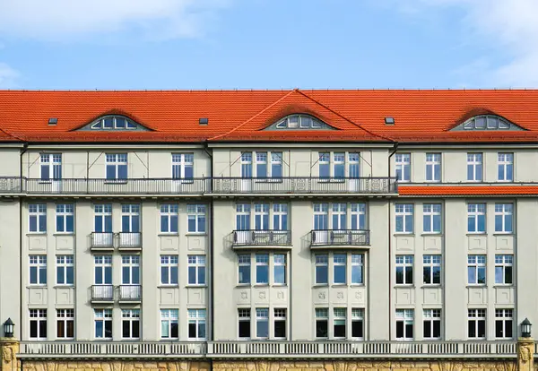 stock image Classic European-style building facade with symmetrical design, featuring bay windows and dormer windows, showcasing traditional urban architecture.