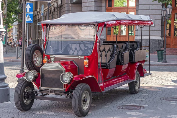 sightseeing car of red color standing in the open air close-up in the city of odessa