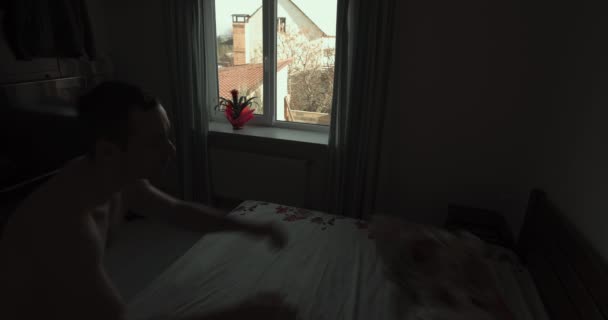 Man Making Bed Morning Throwing Pillows Wide Angle Video — Vídeos de Stock