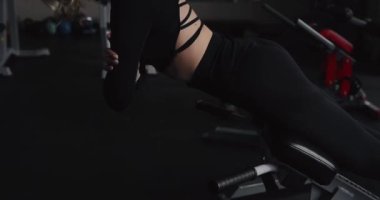 Woman make hyperextension exercise at the gym