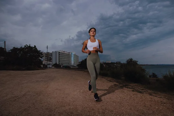 Motivation, sport woman running at the overcast day - Stock Image -  Everypixel