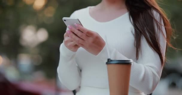 アウトドアカフェに座っているスマートフォンを使用して女性の手を閉じる — ストック動画