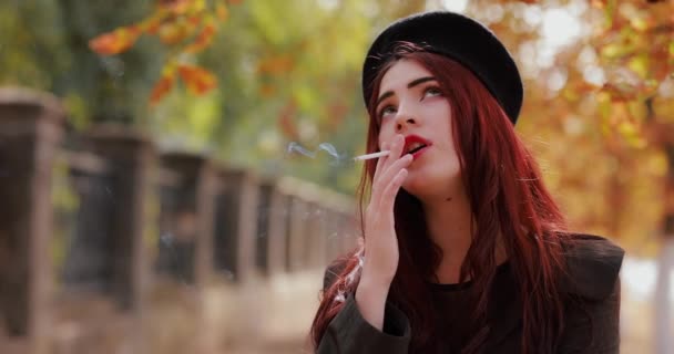 Young Woman Smoking Cigarette Autumn Park Slow Motion — Stock Video