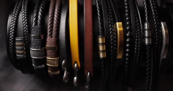 Verzameling Van Lederen Armbanden Verlicht Door Bewegend Licht — Stockvideo