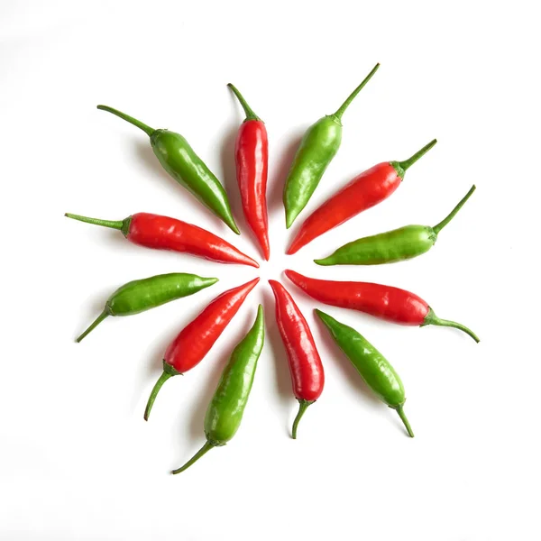 red and green chili peppers on white background