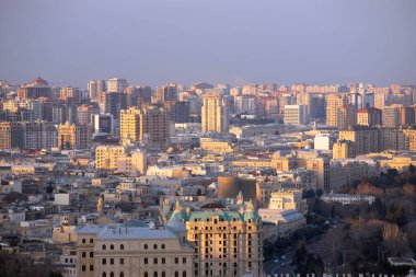 Bakü. Azerbaycan. 03.28.2021. Gün batımında eski ve yeni şehir binaları.