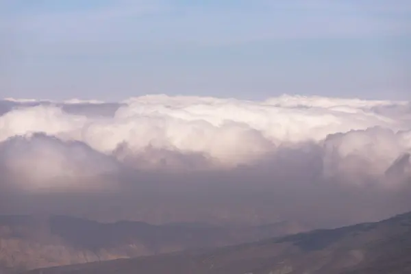 stock image Beautiful white clouds over the mountains. Khyzy region. Azerbaijan.