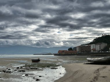 Cloudy sky. Small northern village and beach. High quality photo clipart