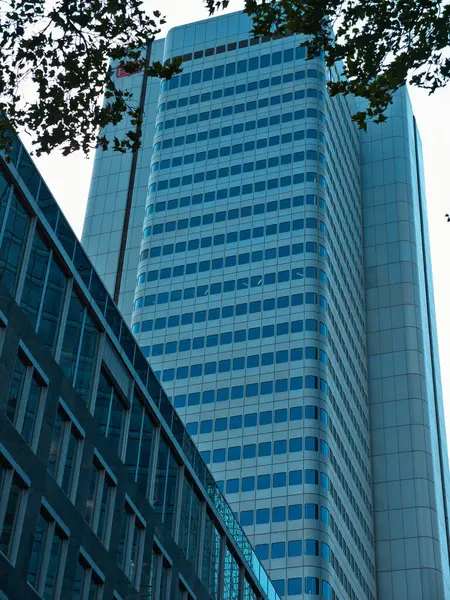 stock image Detail shots of high-rise buildings with a bluish facade and a beautiful shadow play and round architecture background