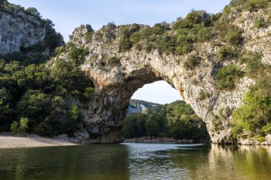 Pont d'Arc empty of tourists from the beach at the foot of the arch