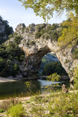 Pont d'Arc empty of tourists from the beach at the foot of the arch