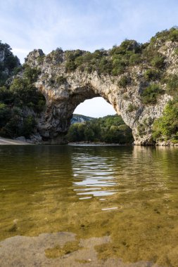 Pont d'Arc empty of tourists from the beach at the foot of the arch