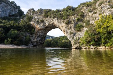 Pont d'Arc empty of tourists from the beach at the foot of the arch