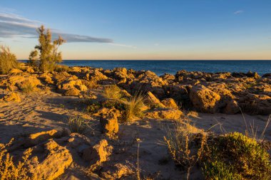 Horizon at sunset over the Mediterranean Sea from the rocks of the Corniche in Sete