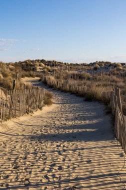 Walk through the sand dunes to Petit Travers beach in Carnon