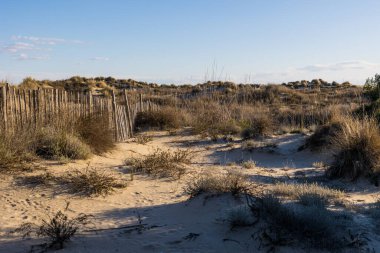 Walk through the sand dunes to Petit Travers beach in Carnon