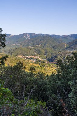 Sunny view of the medieval village of Olargues and the surrounding mountains of the Haut-Languedoc Regional Natural Park