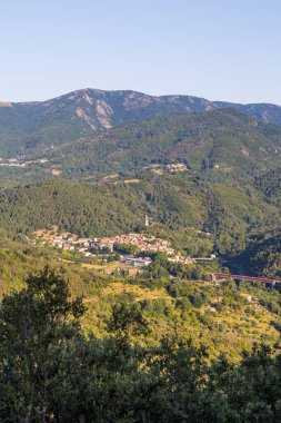 Sunny view of the medieval village of Olargues and the surrounding mountains of the Haut-Languedoc Regional Natural Park