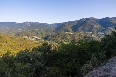 Sunny view of the medieval village of Olargues and the surrounding mountains of the Haut-Languedoc Regional Natural Park