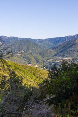 Sunny view of the medieval village of Olargues and the surrounding mountains of the Haut-Languedoc Regional Natural Park