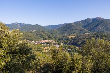 Sunny view of the medieval village of Olargues and the surrounding mountains of the Haut-Languedoc Regional Natural Park