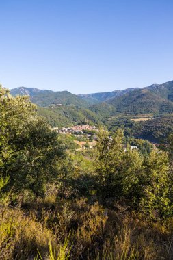 Sunny view of the medieval village of Olargues and the surrounding mountains of the Haut-Languedoc Regional Natural Park