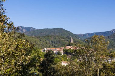 Sunny view of the medieval village of Olargues and the surrounding mountains of the Haut-Languedoc Regional Natural Park