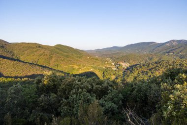 Sunrise view of the medieval village of Olargues and the surrounding mountains of the Haut-Languedoc Regional Nature Park