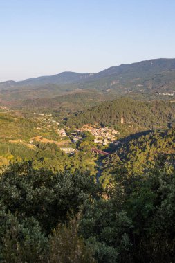 Sunrise view of the medieval village of Olargues and the surrounding mountains of the Haut-Languedoc Regional Nature Park