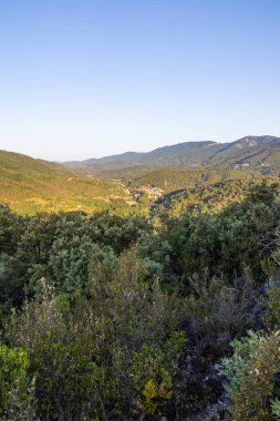 Sunrise view of the medieval village of Olargues and the surrounding mountains of the Haut-Languedoc Regional Nature Park