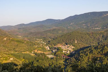 Sunrise view of the medieval village of Olargues and the surrounding mountains of the Haut-Languedoc Regional Nature Park