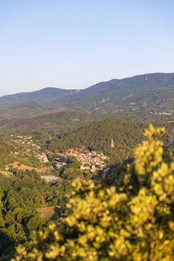Sunrise view of the medieval village of Olargues and the surrounding mountains of the Haut-Languedoc Regional Nature Park