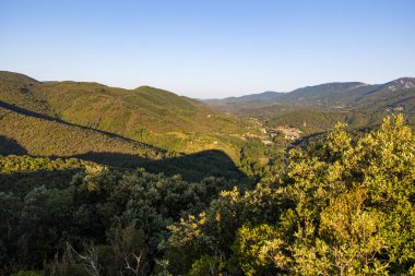 Sunrise view of the medieval village of Olargues and the surrounding mountains of the Haut-Languedoc Regional Nature Park