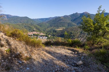 Sunny view at the bend of a hiking path on the medieval village of Olargues in the Haut-Languedoc Regional Natural Park