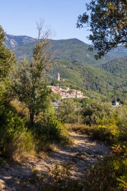 Sunny view at the bend of a hiking path on the medieval village of Olargues in the Haut-Languedoc Regional Natural Park