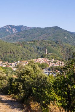 Sunny view at the bend of a hiking path on the medieval village of Olargues in the Haut-Languedoc Regional Natural Park