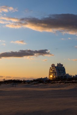 Le Poseidon building by architect Jean Balladur, on the edge of Couchant beach, at sunset