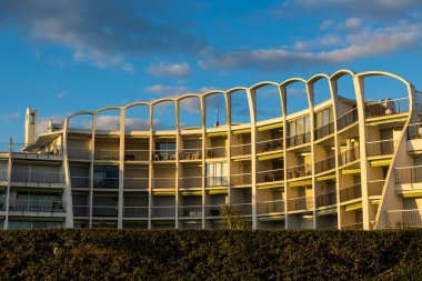 View of the buildings of the Couchant district from the dunes of the beach in La Grande-Motte at sunset