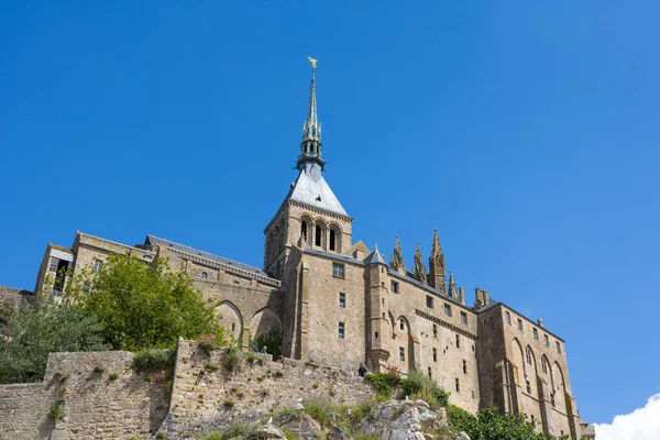 stock image View from below on the Abbey of Mont Saint-Michel and its bell tower topped by the Archangel Saint-Michel