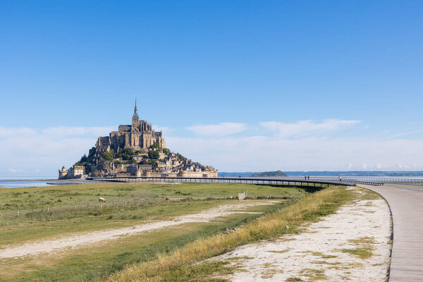 View on the Mont Saint-Michel in front of a salt meadow pasture and its lambs